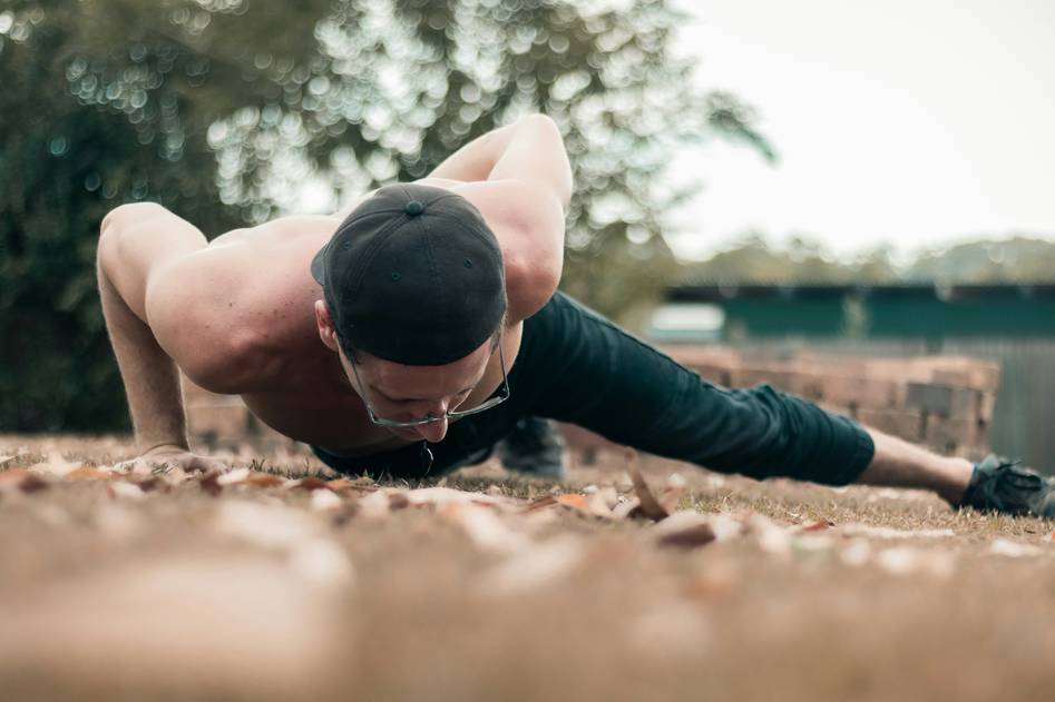 Person performing calisthenics push-up outdoors